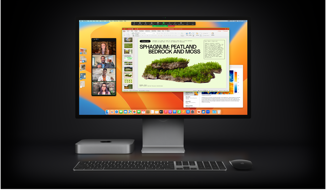 Mac mini egy Magic Mouse, egy Magic Keyboard, valamint egy Studio Display mellett, amelyen egy Zoom-értekezleten megosztott Microsoft PowerPoint-prezentáció jelenik meg, háttérben a Jegyzetek appal.