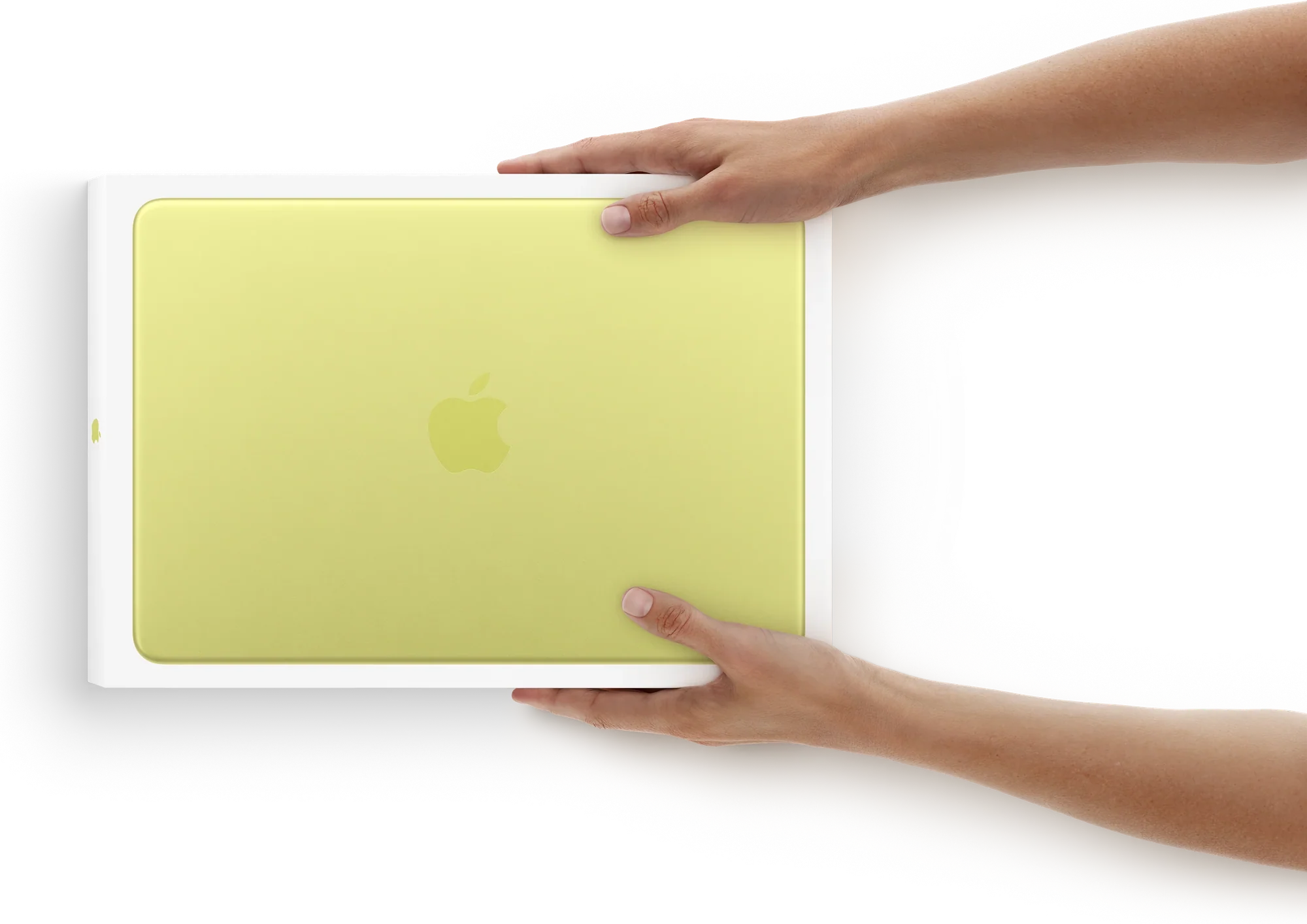 Kezek egy dobozos, citrus színű MacBook Neo készülékkel
